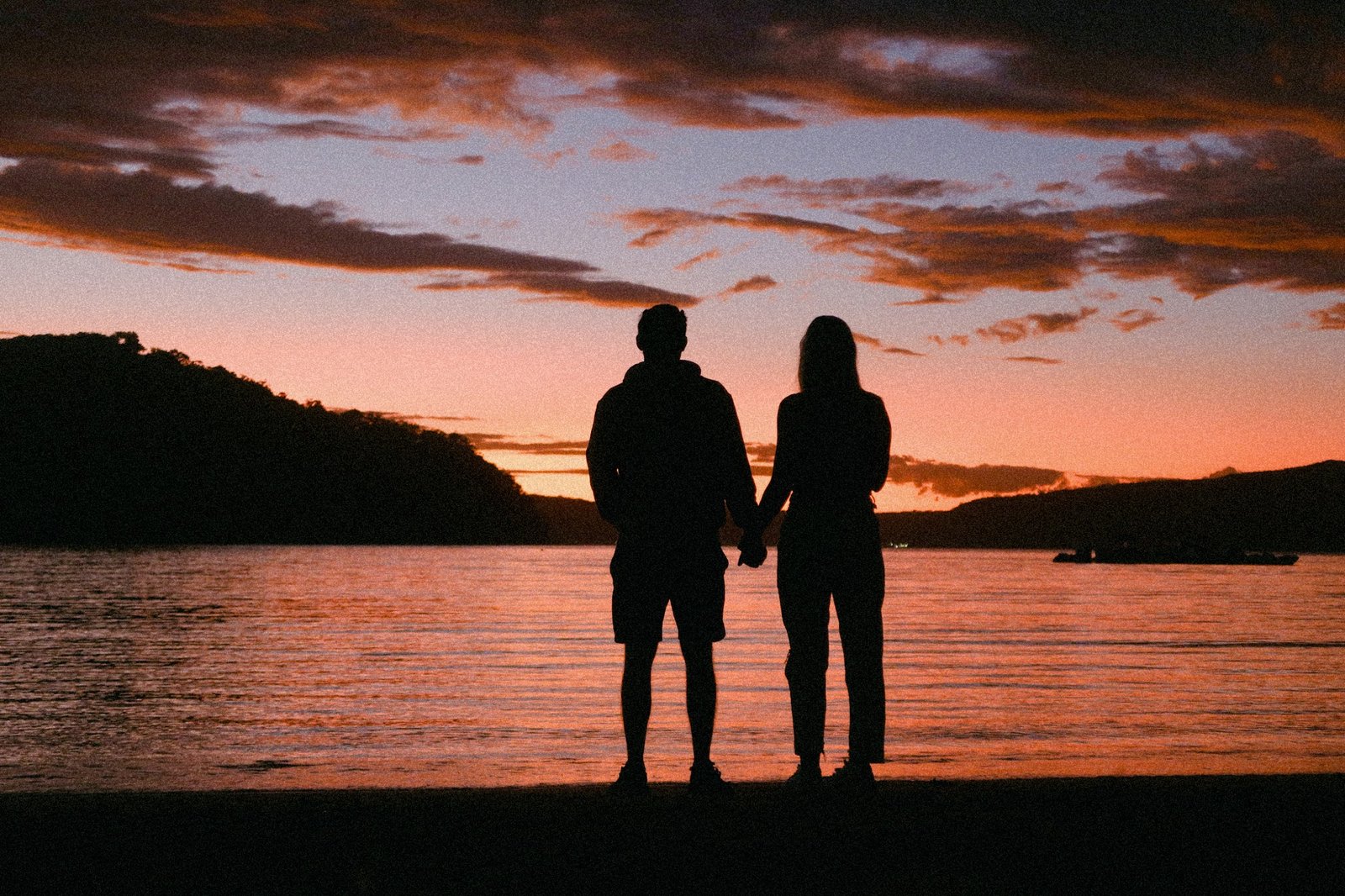 Daniel and Lauren holding hands at sunset