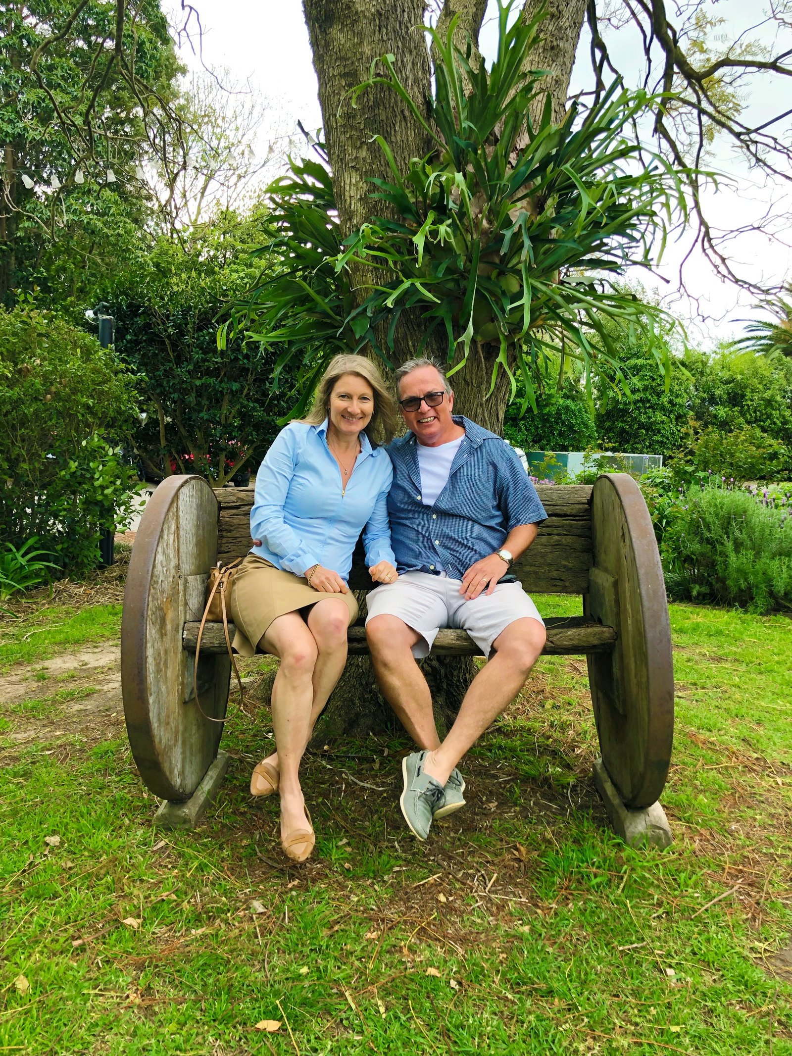 Dianne and Glenn sitting together on a garden bench